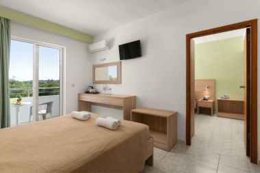 Two bedroom apartment with pool view, bed desk and flat screen